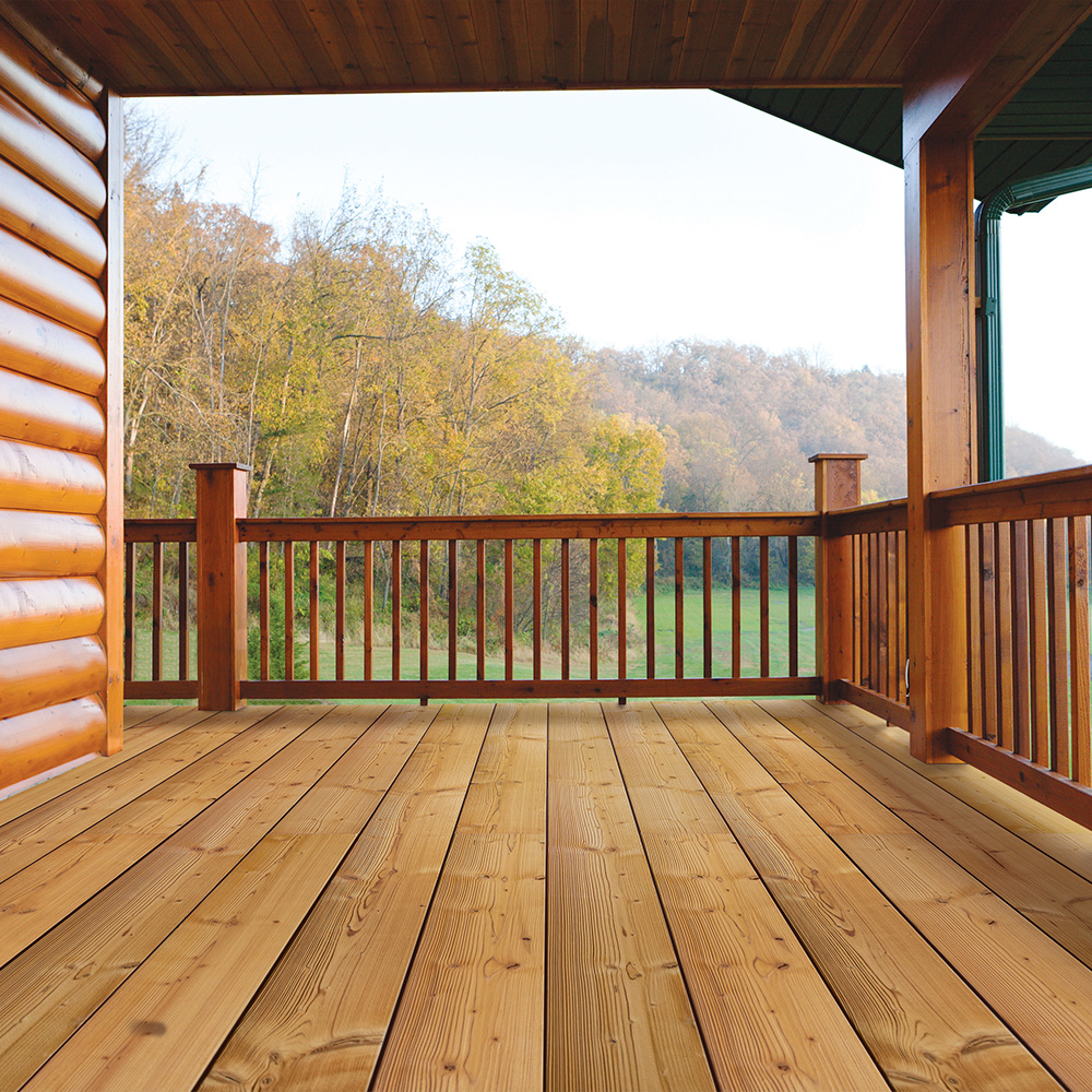 A Thermory thermally-modified wood deck and porch overlooking autumn trees
